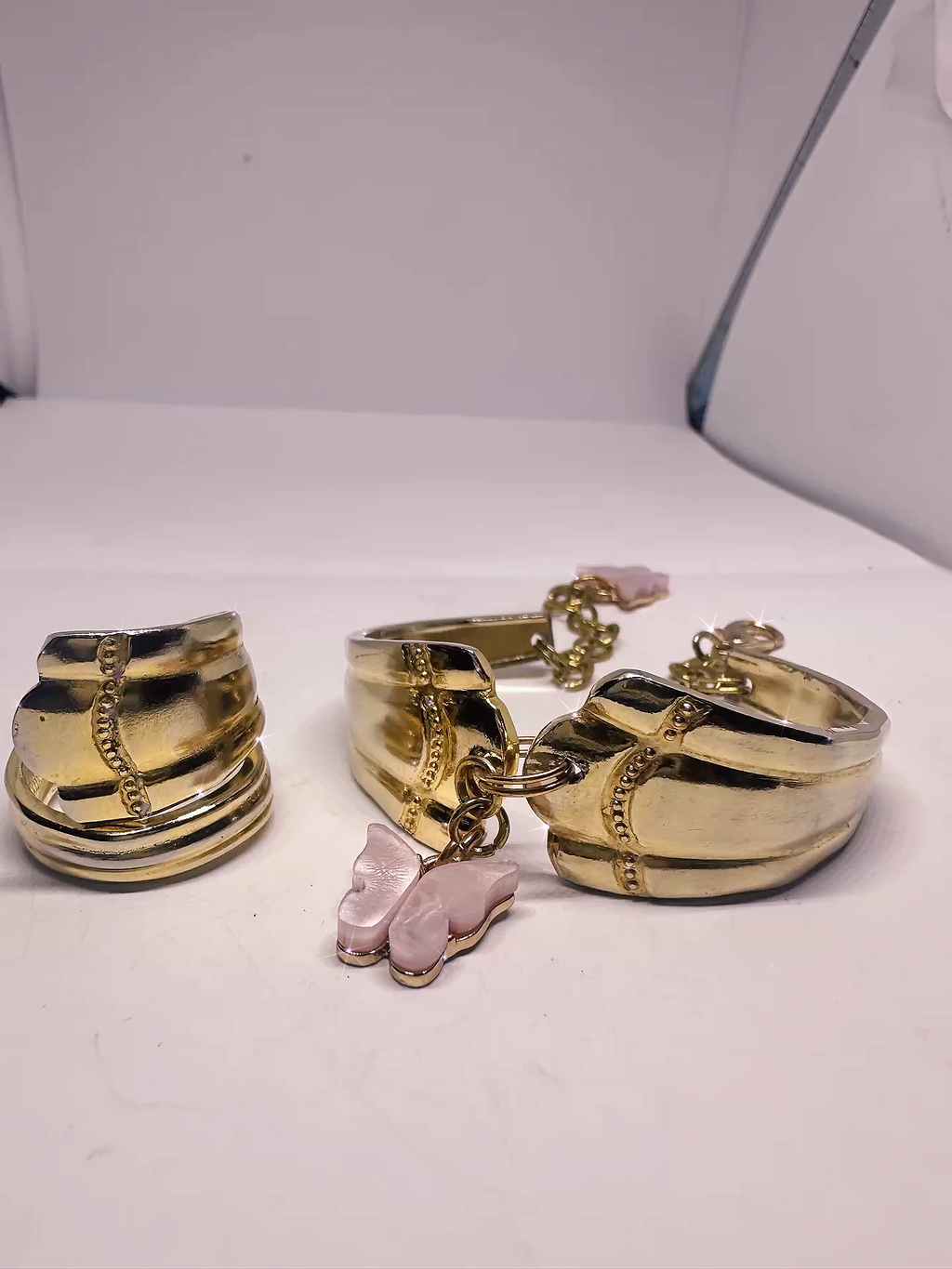 Gold Spoon Ring & Bracelet Set – Textured Design with Pink Butterfly Char in a styled setting, emphasizing the modern vintage aesthetic of the jewelry pieces.