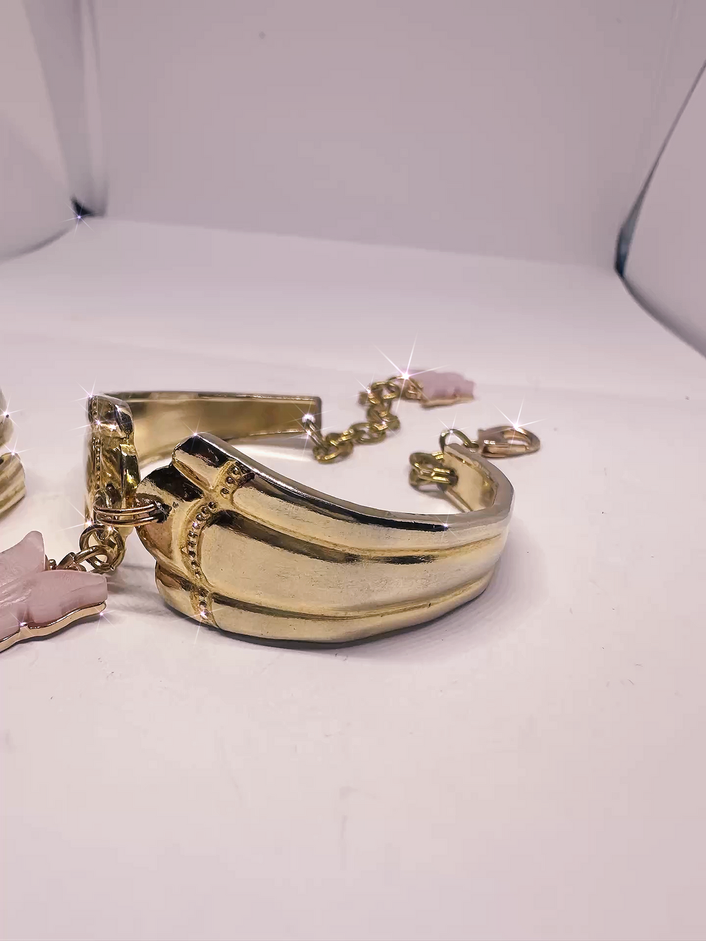 Close-up of the Gold Spoon Bracelet from the Gold Spoon Ring & Bracelet Set, highlighting the elegant curved design and pink butterfly charm on a shiny gold finish.