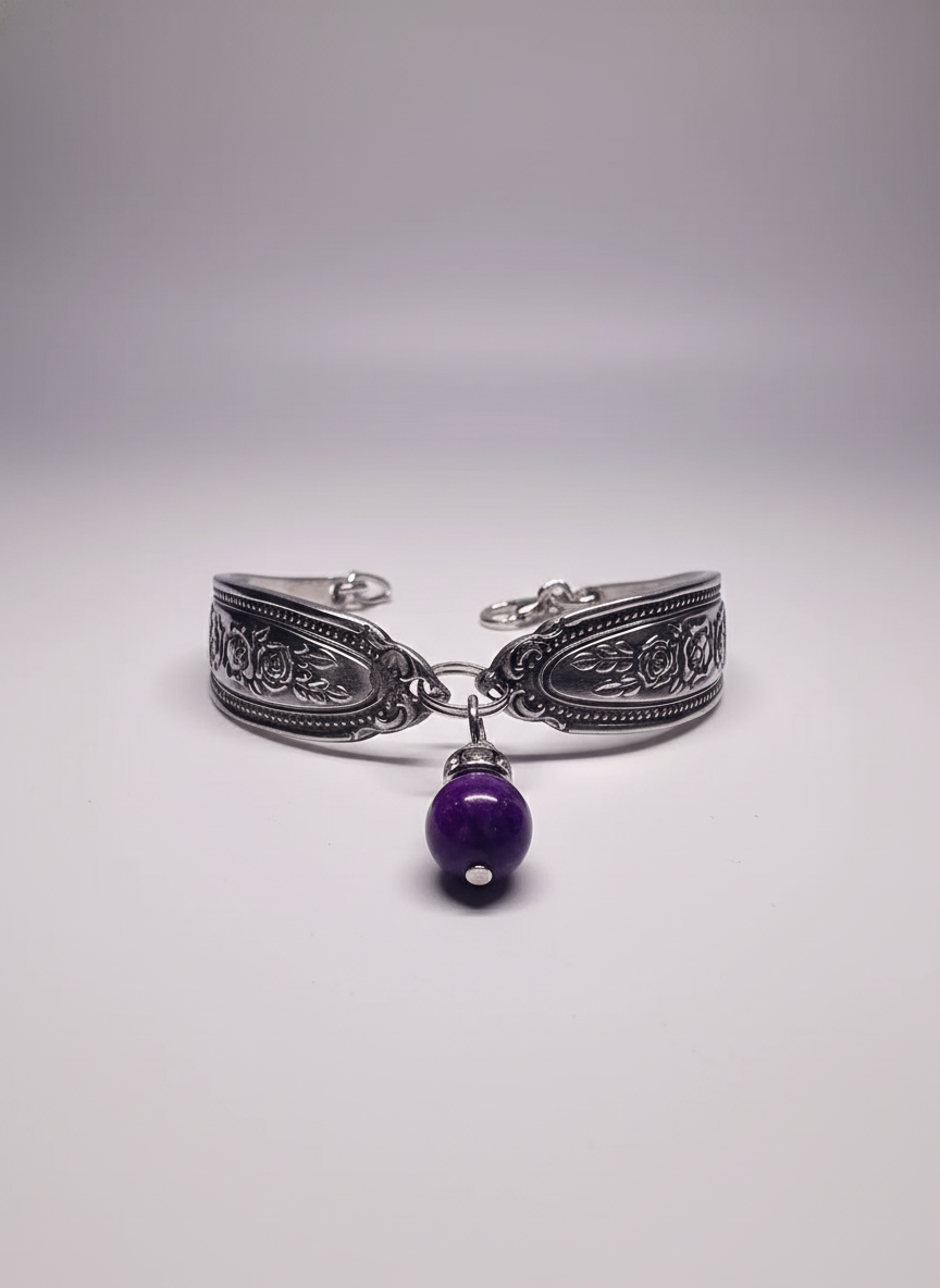 Amethyst Spoon Bracelet featuring intricate floral engravings, crafted from vintage stainless steel, highlighted by a deep purple amethyst cabochon.