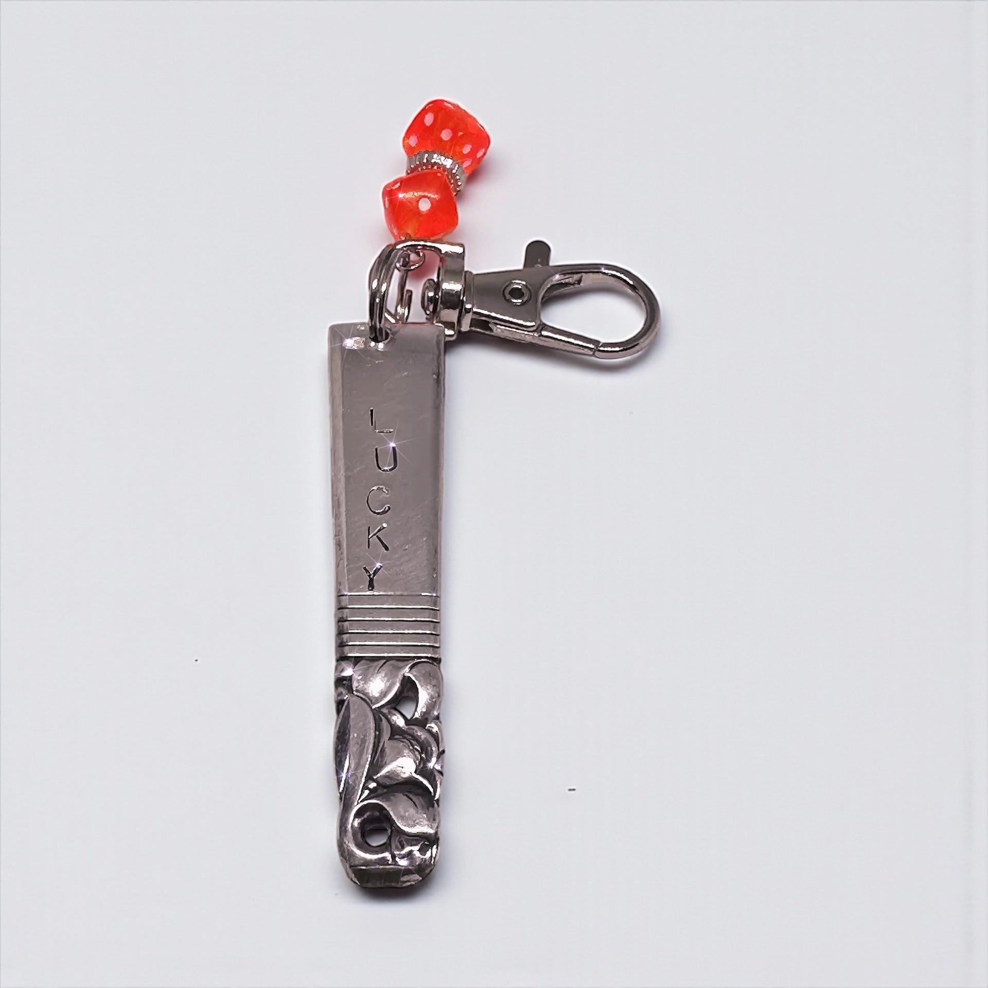 Hand-Stamped Lucky Scratch Card Keychain featuring a vintage spoon handle, stamped with 'LUCKY,' and adorned with a playful red dice charm.