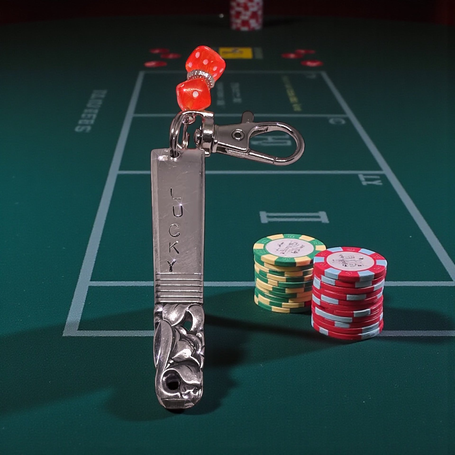 Hand-Stamped Lucky Scratch Card Keychain displayed on a poker table with chips, highlighting its unique design and practical use for scratch cards.