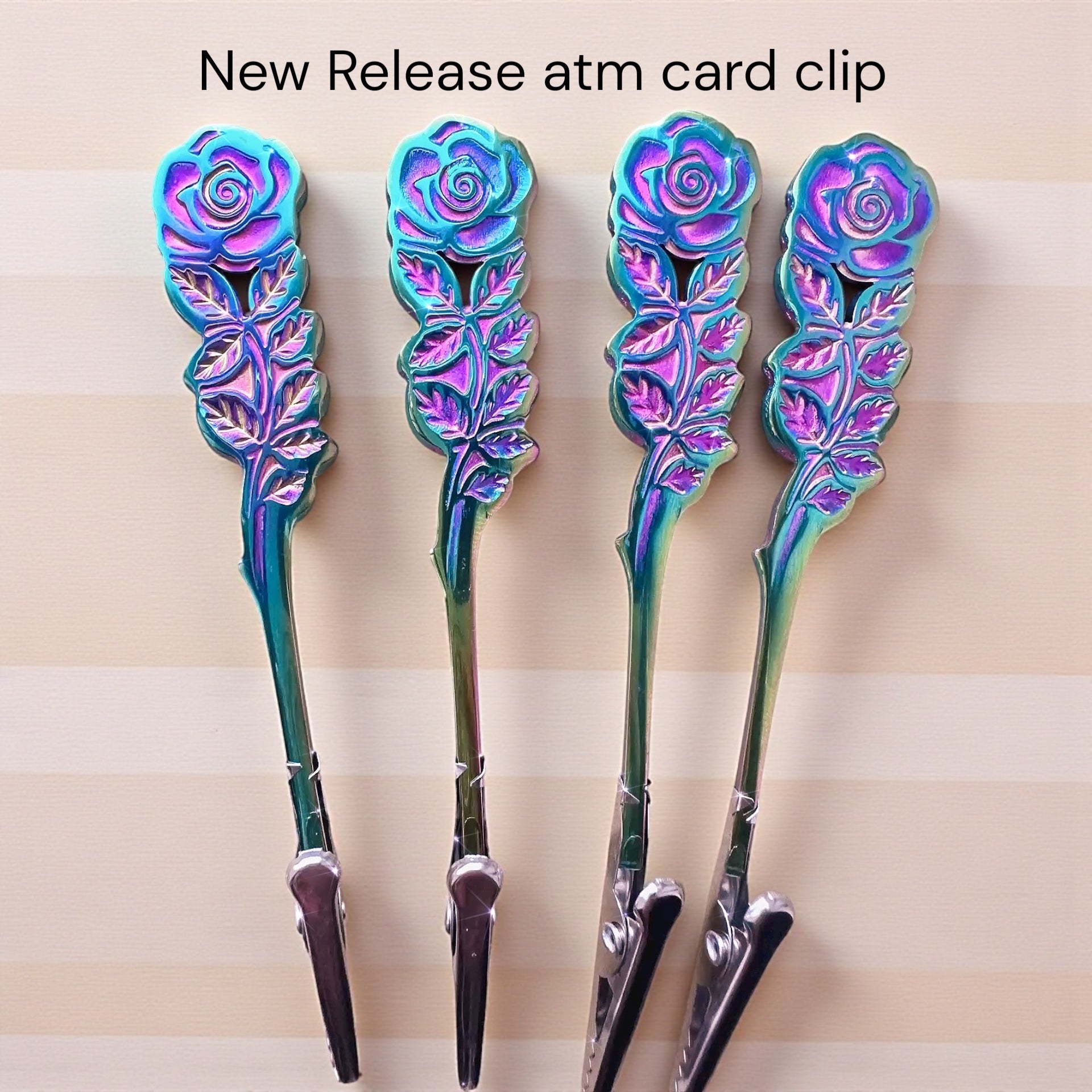 Four decorative ATM card clips with rose design on a beige background