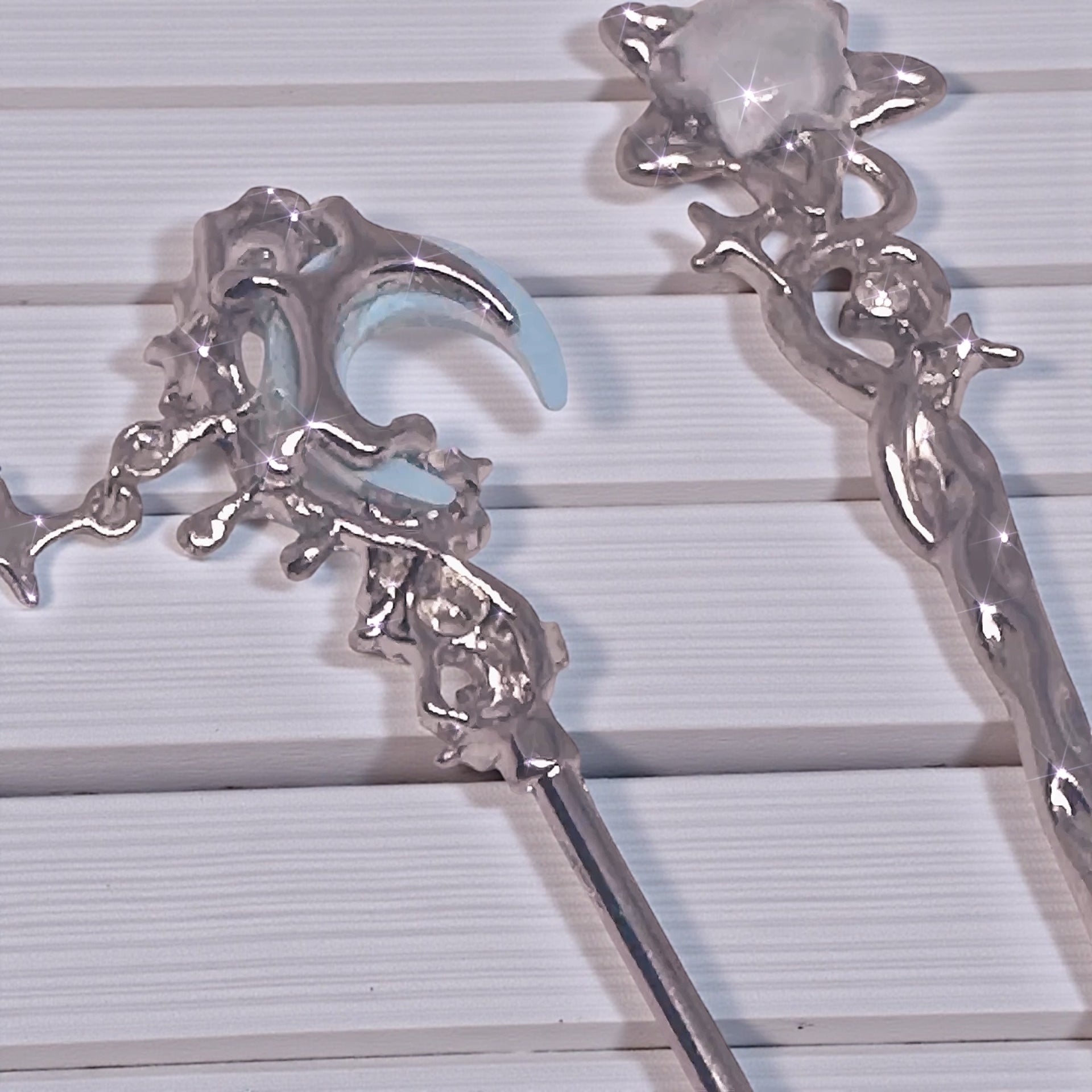 Detailed shot of the Bracelet Helper & ATM Card Clip highlighting intricate celestial charms and shiny finish, perfect for retrieving small items.