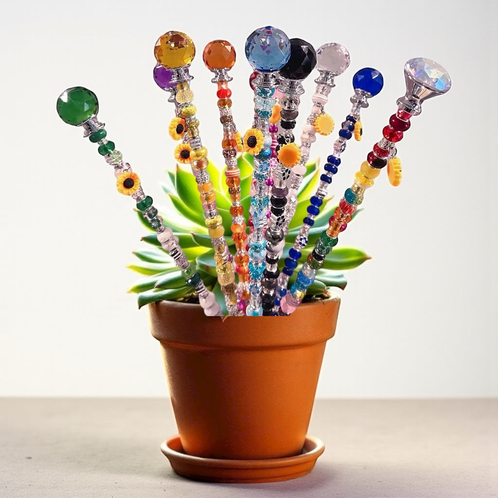 Colorful Garden Fairy Wands showcased in a terracotta pot. Perfect decorative plant stakes to add whimsy to your gardening space. Handmade with beads and crystals.