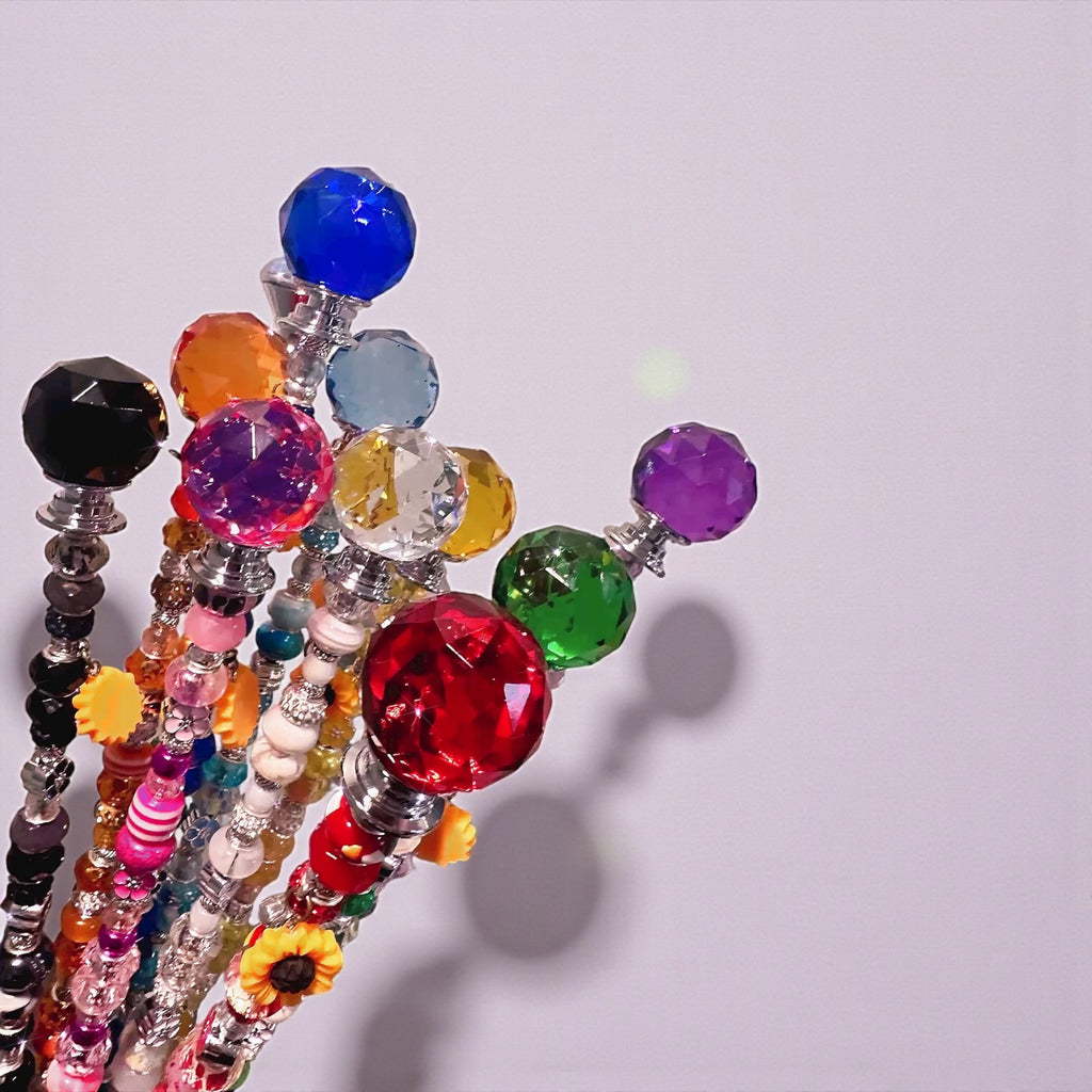 Close-up of colorful bead and crystal accents on Garden Fairy Wands, highlighting their unique handmade features for plant decoration.