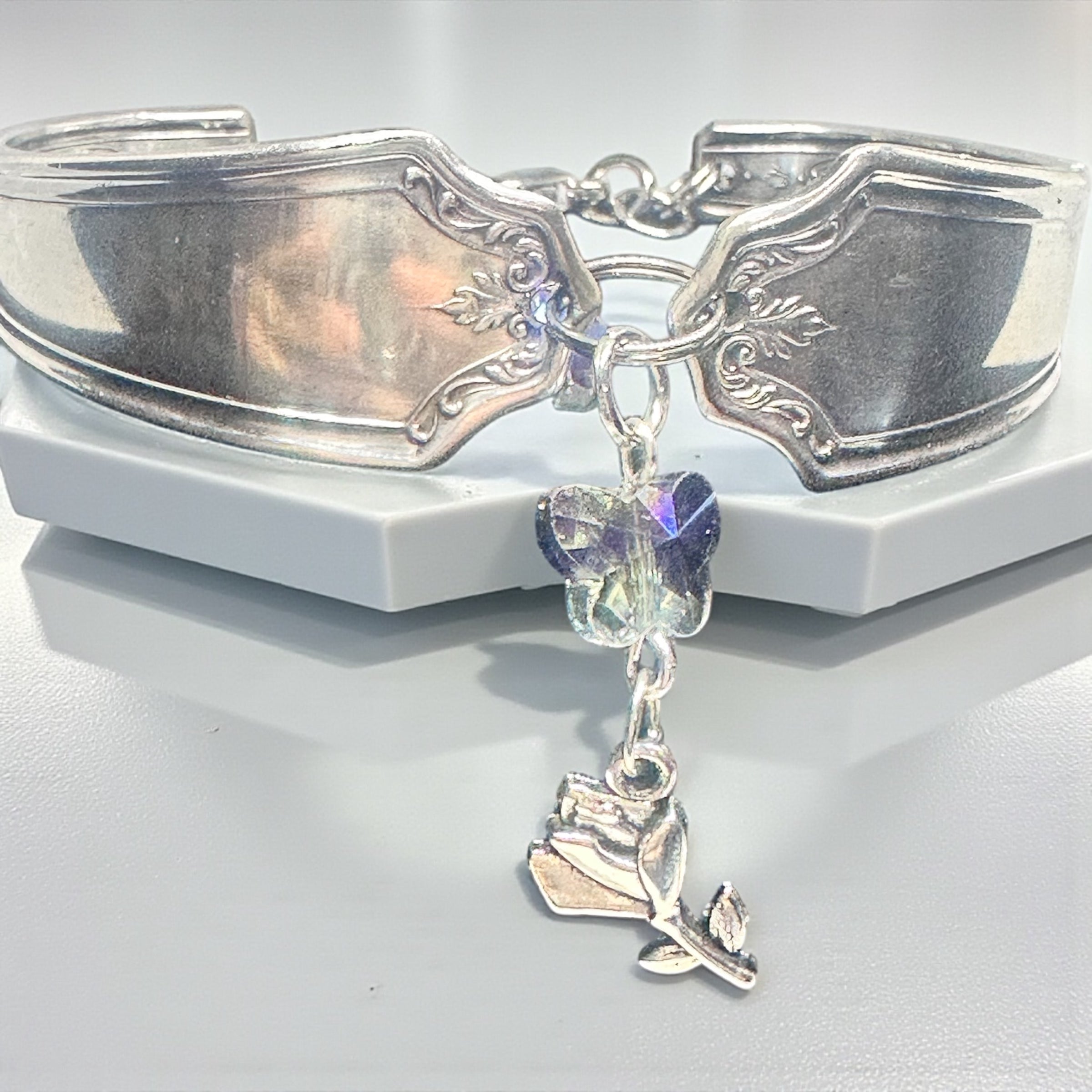 Silver bracelet with charms on a white background