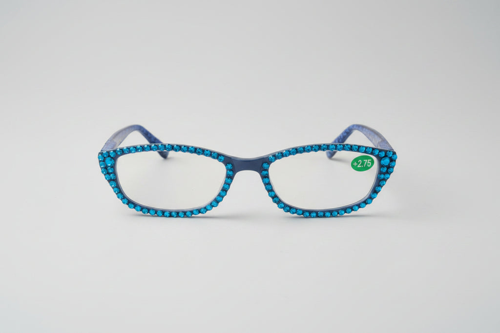 Blue decorative glasses on a textured surface