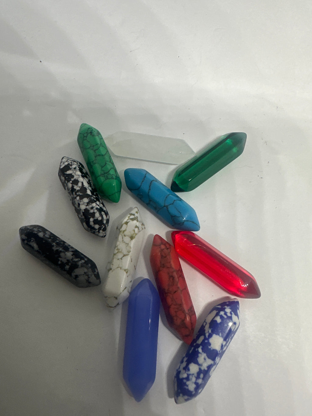 Genuine Gemstone Clip – ATM Card Grabber, & Bracelet Helper displaying an assortment of stones like Aventurine, Turquoise Howlite, and more on a white surface.