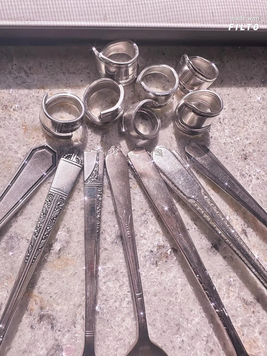 Custom Spoon Jewelry - Assorted vintage silverware including spoons and rings, ideal for creating custom jewelry pieces.